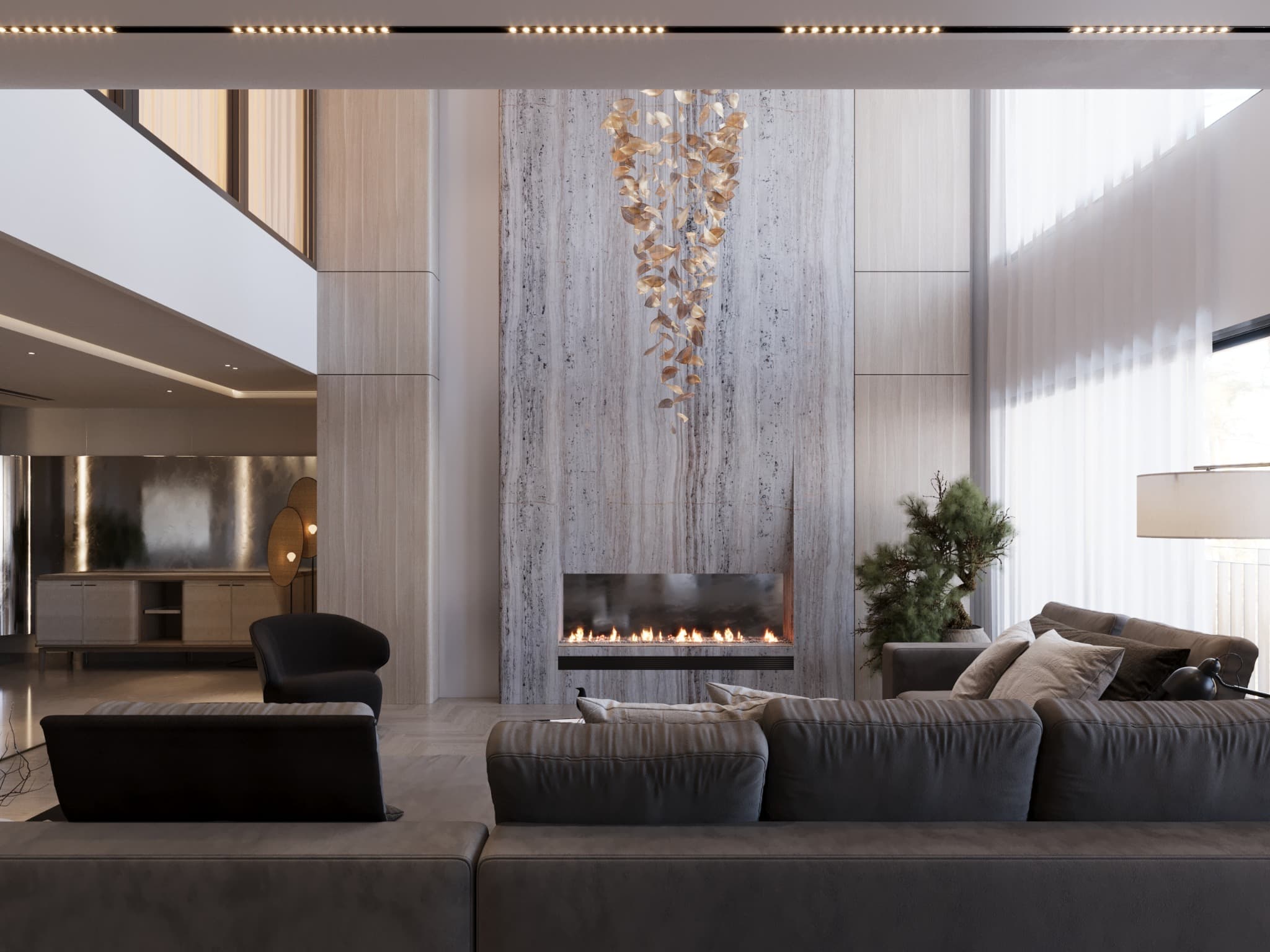 Double-height living room with a travertine fireplace wall and suspended leaf chandelier