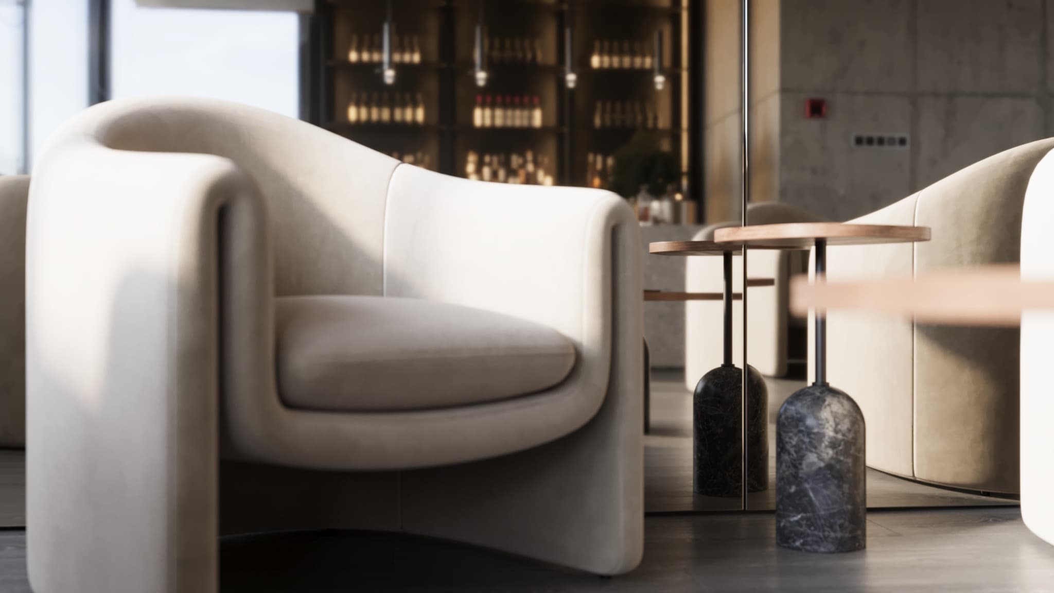 Close view of an armchair's curved back, padded seat and slim table edges