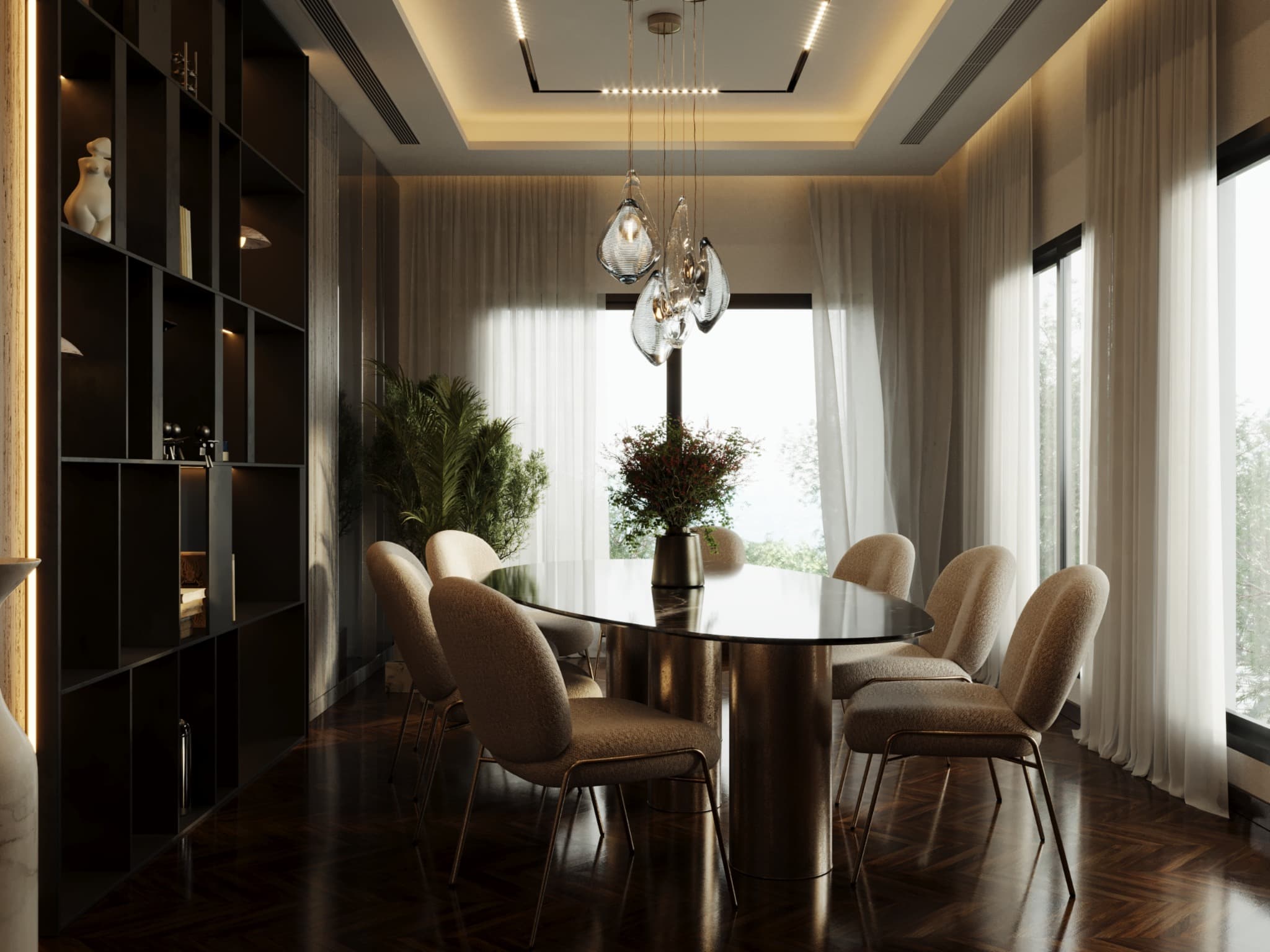 Dining table with dark top and pale upholstered chairs beside open shelving