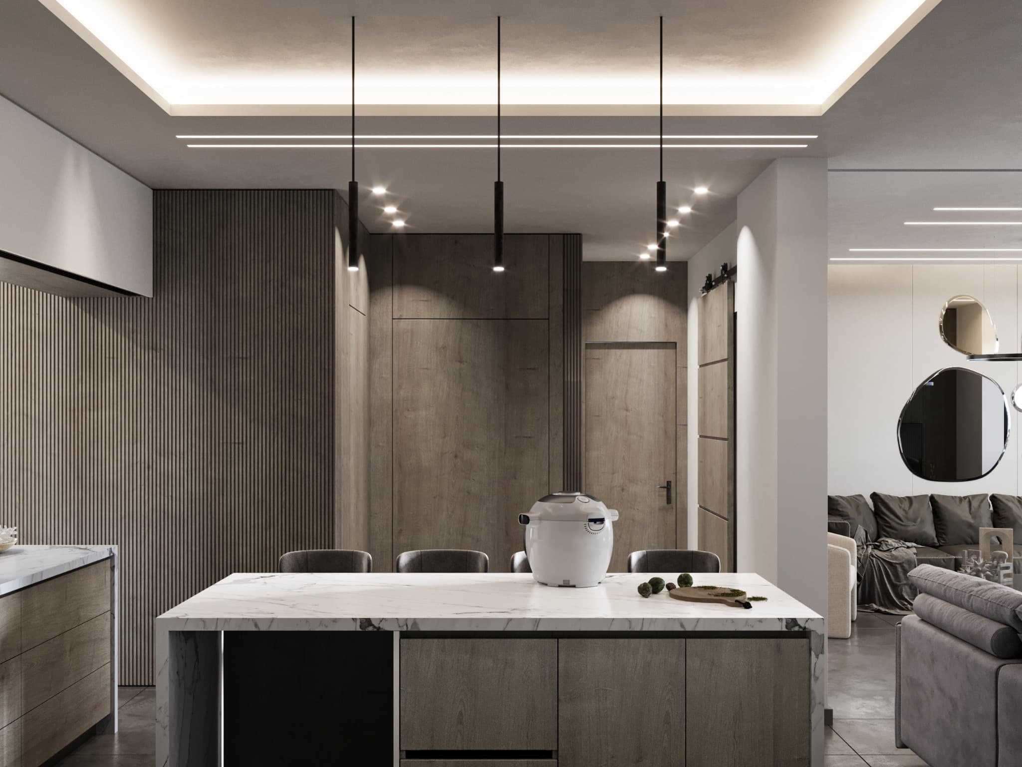 Pale kitchen island beneath slim black pendants against full-height cabinetry