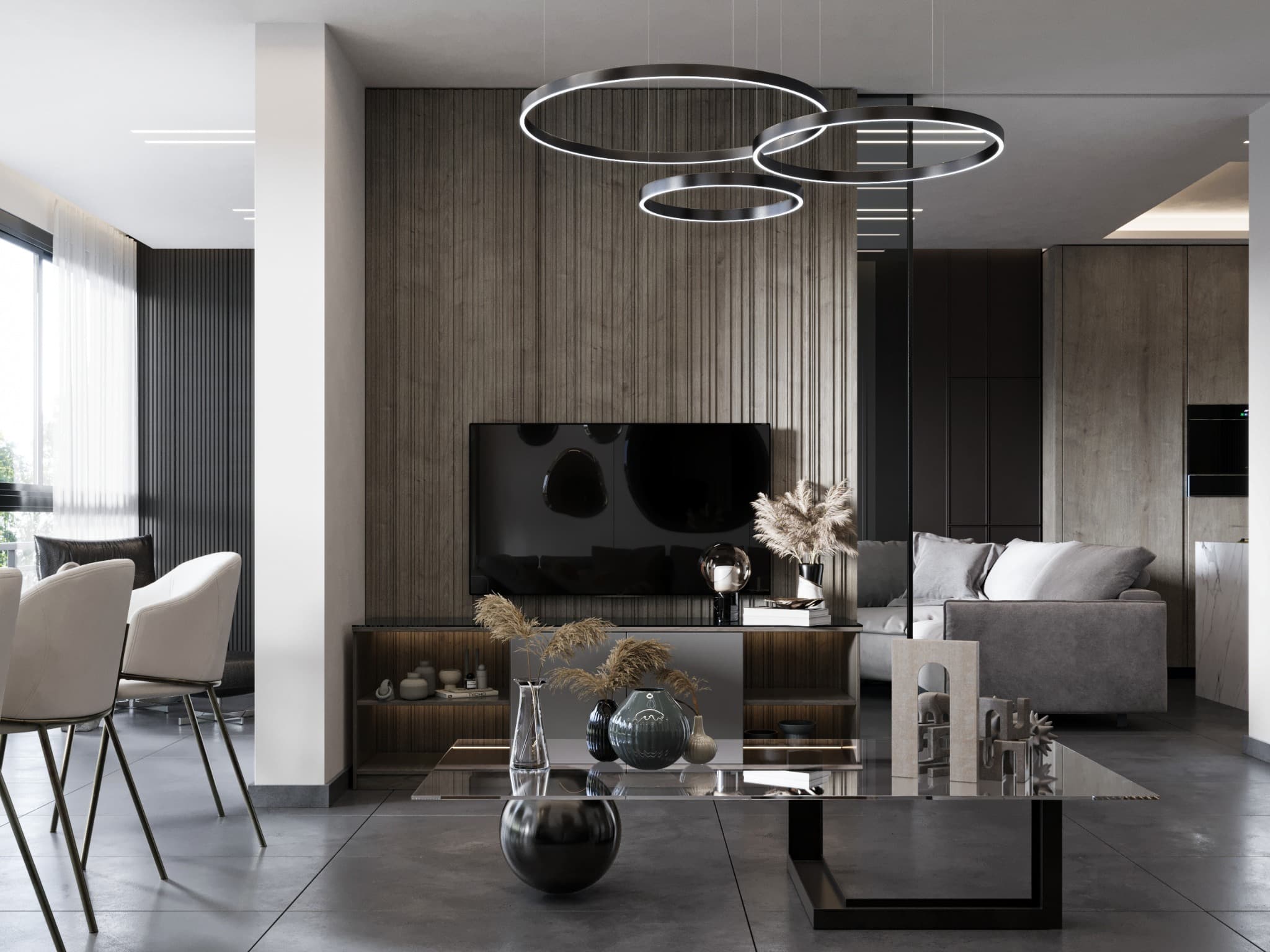 Suspended rings and a vertically textured media wall above reflective tables