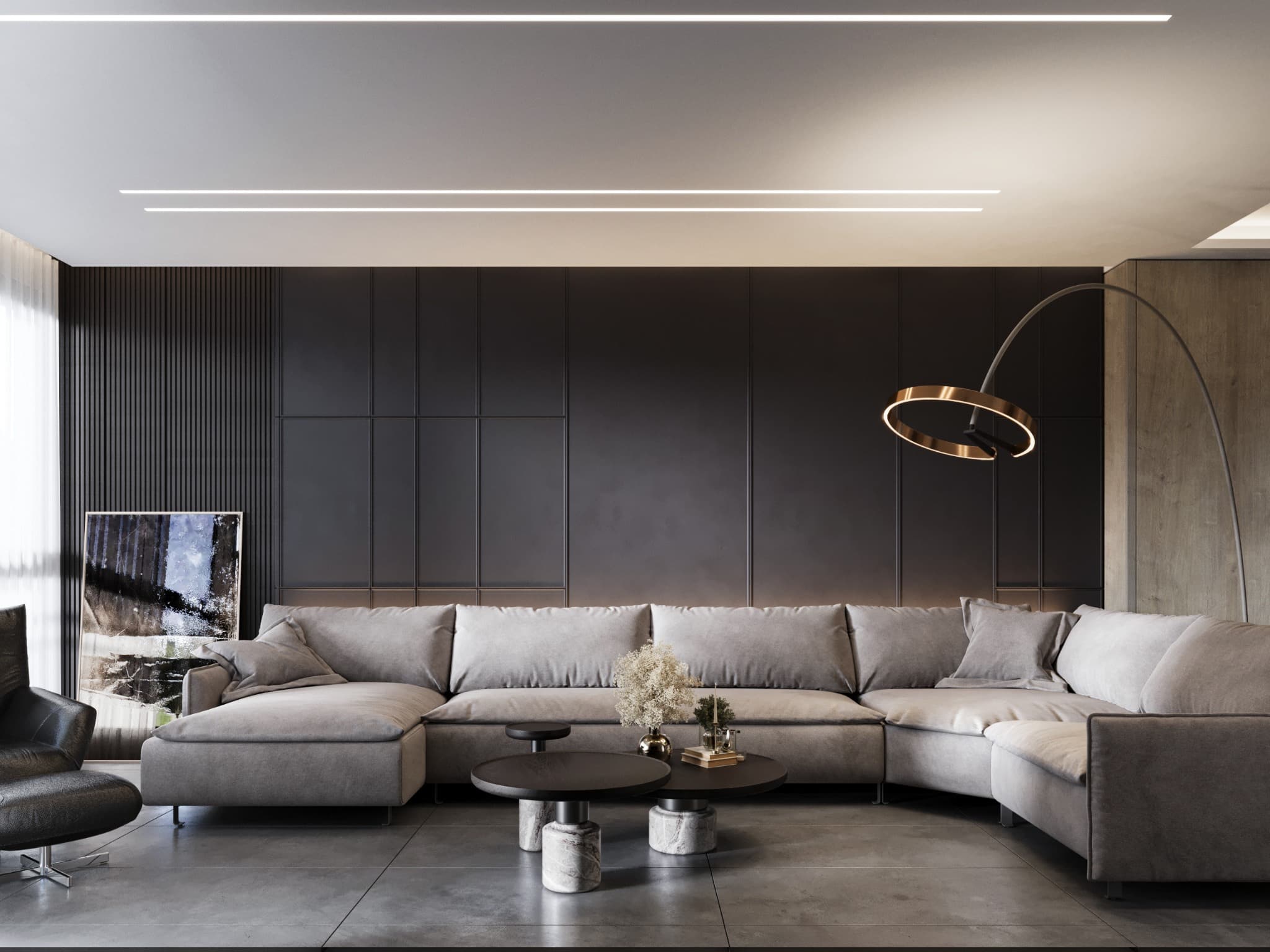 Generous sectional sofa against a dark panelled wall beneath a slender arc lamp