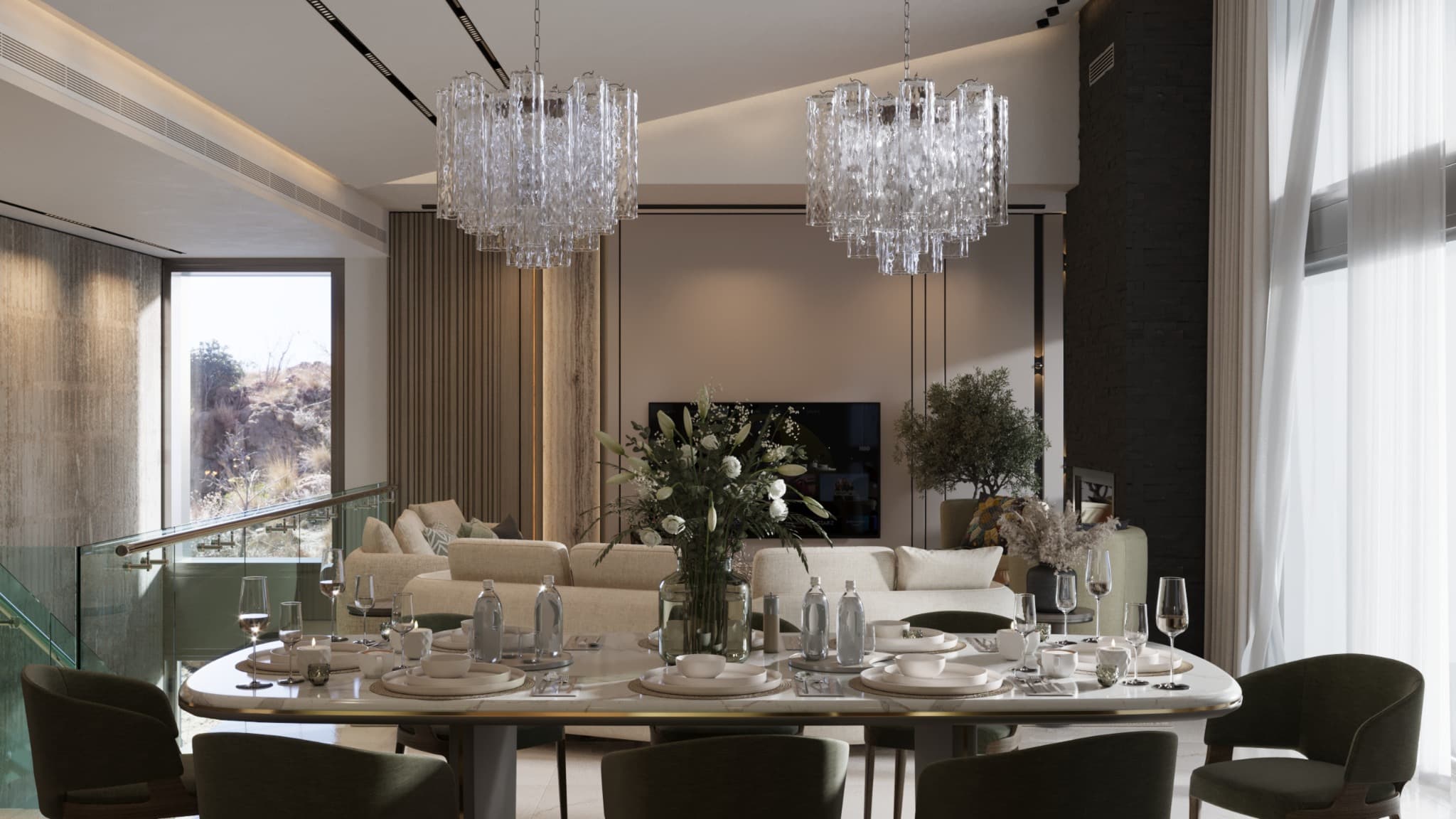 Dressed dining table beneath two decorative pendants with the living area beyond