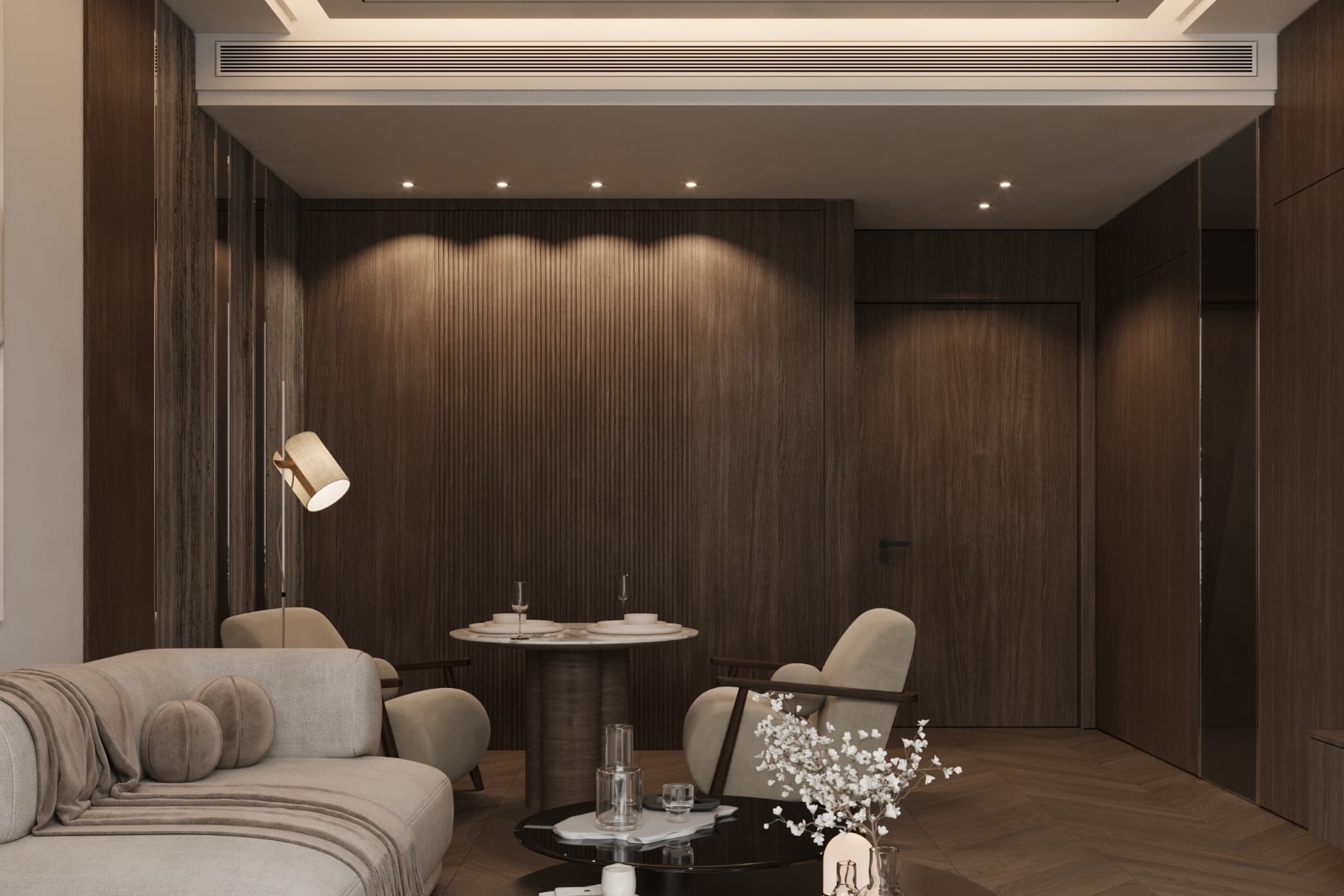 Small table and upholstered chairs against broad timber panels