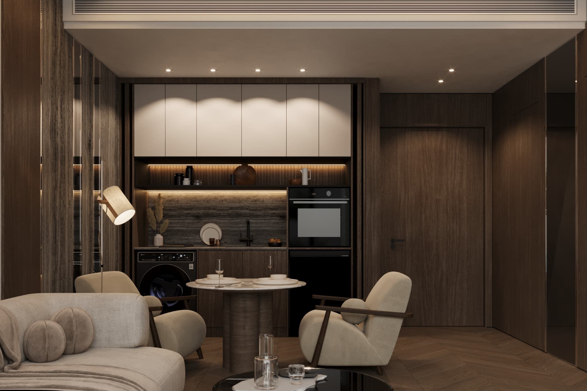 Compact kitchen with dark cabinetry and warm shelving behind the sitting area